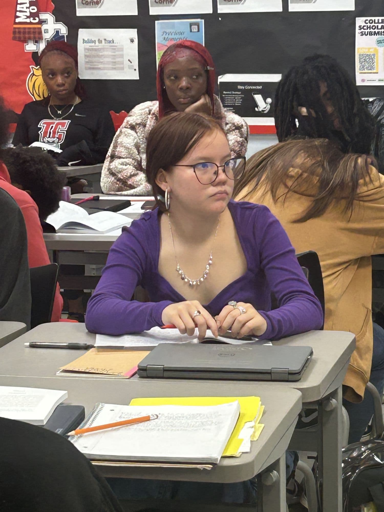 A student working through Velocity lesson materials at her desk during class