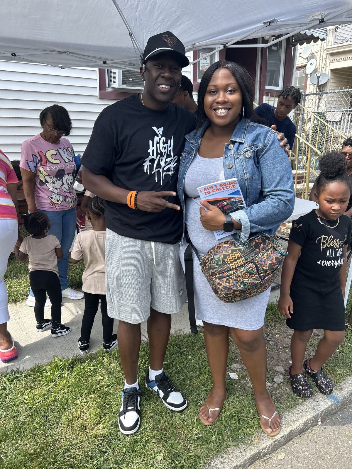 Marlo Prioleau with a parent and children at a community family event