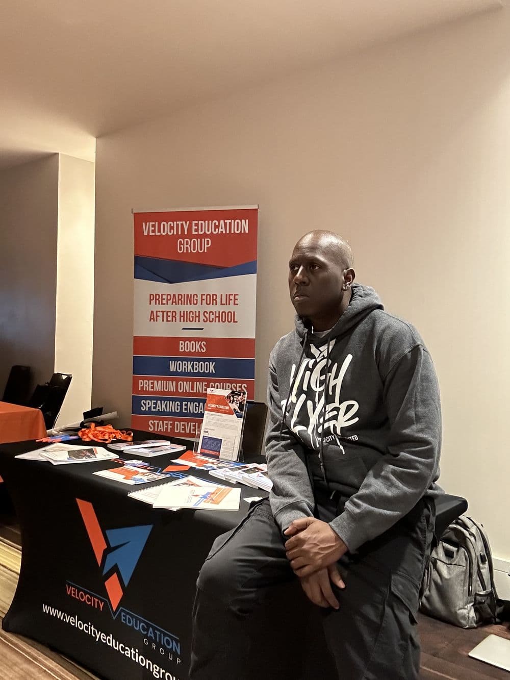Velocity Education Group program materials and banner set up at a school site